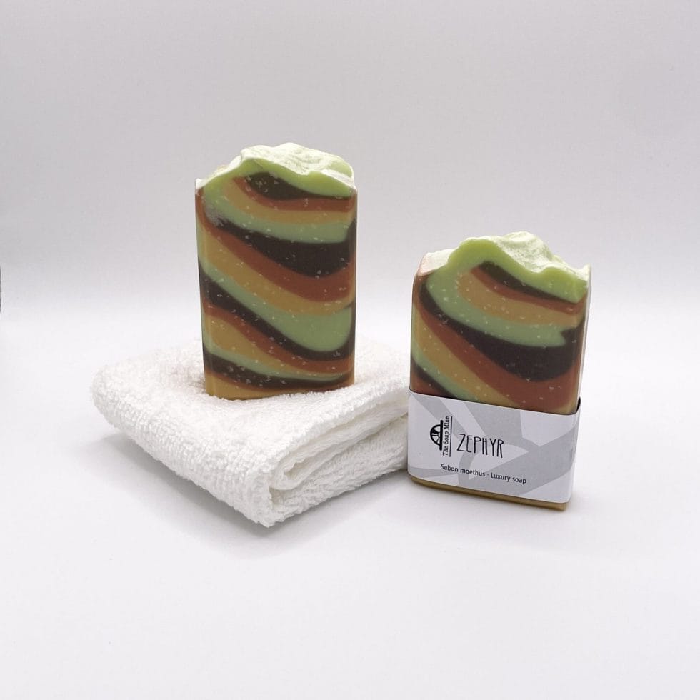 two bars of Zephyr Handmade Soap and a white facecloth
