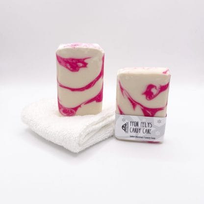 Two bars of white and red soap and a white facecloth