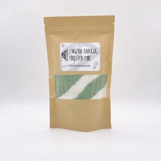 A resealable kraft bag with a window showing the green and white bath sprinkles inside