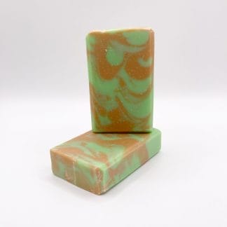 Two bars of brown and green handmade soap
