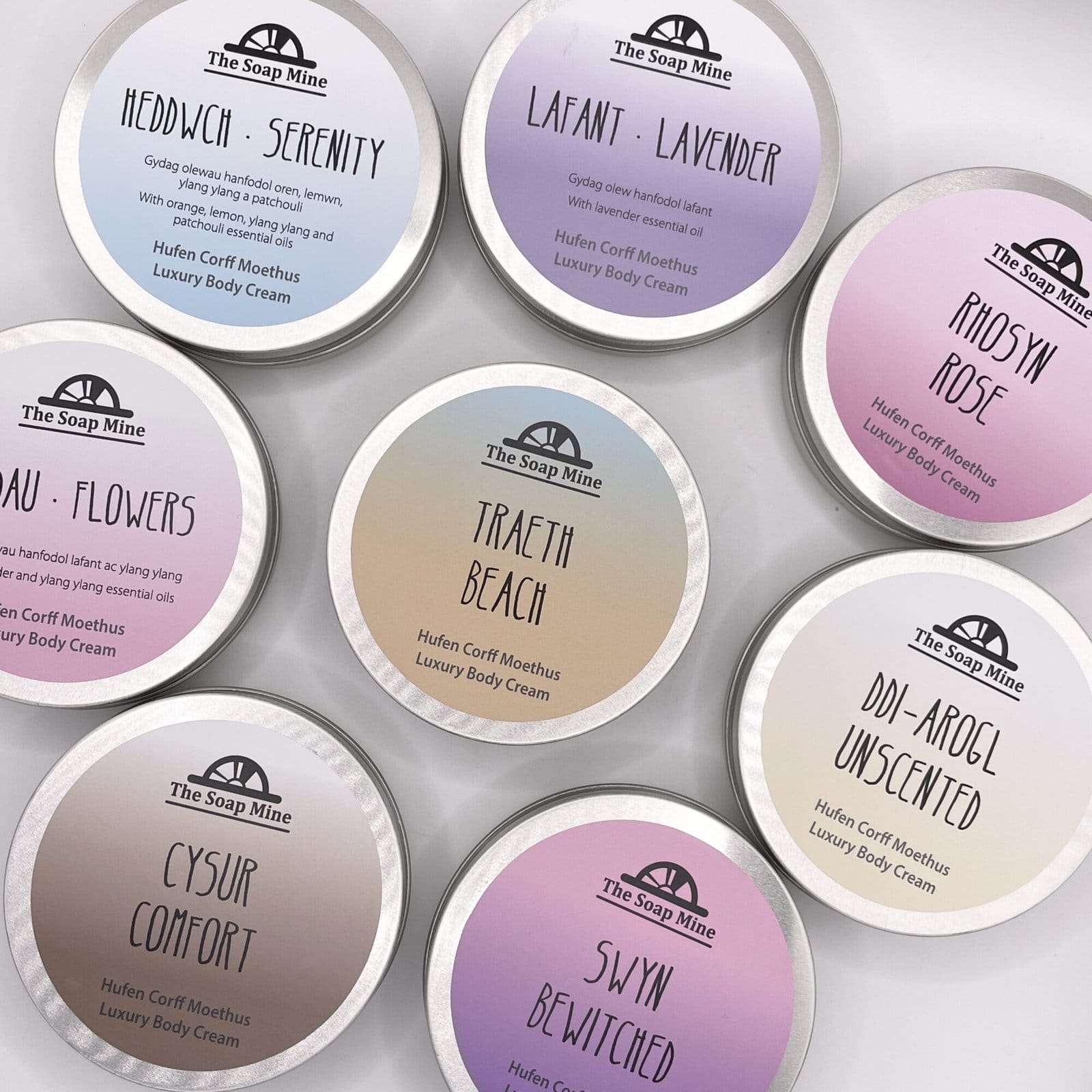 A set of eigh different tins of body cream