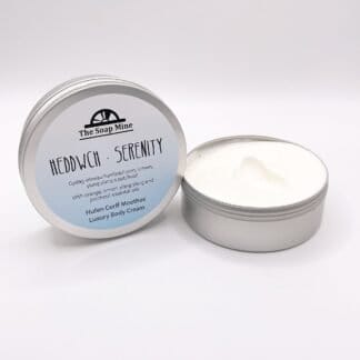 A tin of body cream with a blue label