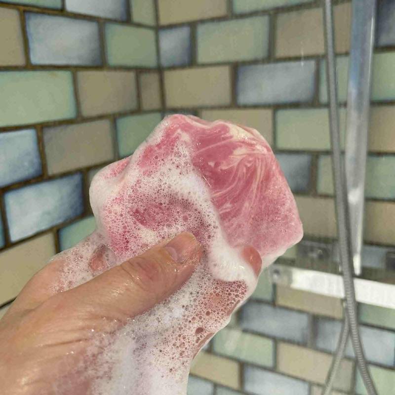 A bar of pink rose scented handmade soap