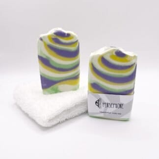 Two bars of purple, white and green handmade soap
